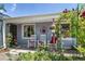 Inviting front porch with rocking chairs, decorative compass, and beautiful floral decor at 2440 Saulsbury St, Lakewood, CO 80214