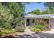 Charming home with a well-manicured front yard, landscaping, and welcoming entrance at 2440 Saulsbury St, Lakewood, CO 80214