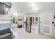 Bright kitchen with stainless steel refrigerator, white cabinetry, and view to breakfast nook at 2440 Saulsbury St, Lakewood, CO 80214
