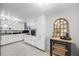 Bright white kitchen featuring modern appliances and ample storage space at 2440 Saulsbury St, Lakewood, CO 80214