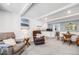 Comfortable living space featuring beamed ceilings and an adjacent dining area at 2440 Saulsbury St, Lakewood, CO 80214