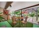 Enjoy this covered patio with artificial turf and a pergola overlooking a lush backyard at 2440 Saulsbury St, Lakewood, CO 80214