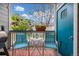 Relaxing balcony area with seating and a view of the surrounding greenery and blue sky at 8465 Pebble Creek Way # 102, Highlands Ranch, CO 80126