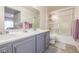 Bright bathroom with double sinks, a walk-in shower, and lots of natural light at 8465 Pebble Creek Way # 102, Highlands Ranch, CO 80126