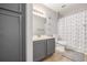Bathroom featuring a sleek vanity, ample counter space, and shower with curtain at 8465 Pebble Creek Way # 102, Highlands Ranch, CO 80126