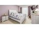 Cozy bedroom with a queen bed, soft lighting, and neutral color palette at 8465 Pebble Creek Way # 102, Highlands Ranch, CO 80126