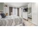 Comfortable bedroom featuring ample closet space, large window, and warm neutral tones at 8465 Pebble Creek Way # 102, Highlands Ranch, CO 80126