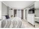 Comfortable bedroom featuring an area rug, a TV and a dresser with a mirror at 8465 Pebble Creek Way # 102, Highlands Ranch, CO 80126