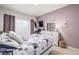 Comfortable bedroom featuring an area rug, a TV and a dresser with a mirror at 8465 Pebble Creek Way # 102, Highlands Ranch, CO 80126