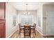 Bright dining room featuring wood-look floors, a large window, and seating for four at 8465 Pebble Creek Way # 102, Highlands Ranch, CO 80126