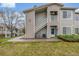 Well-maintained building exterior with manicured lawn and inviting entrance with stairs to upper units at 8465 Pebble Creek Way # 102, Highlands Ranch, CO 80126