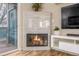 Modern fireplace nestled between balcony access and entertainment center for cozy living at 8465 Pebble Creek Way # 102, Highlands Ranch, CO 80126