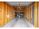 Spacious unfinished garage with shelving and ample room for parking and storage at 8465 Pebble Creek Way # 102, Highlands Ranch, CO 80126
