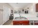 Bright kitchen with stainless steel sink and an open concept view into living room at 8465 Pebble Creek Way # 102, Highlands Ranch, CO 80126