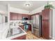 Well-equipped kitchen with stainless steel appliances, and cherry wood cabinets at 8465 Pebble Creek Way # 102, Highlands Ranch, CO 80126