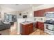 Modern kitchen with stainless steel appliances and open view to the living room at 8465 Pebble Creek Way # 102, Highlands Ranch, CO 80126