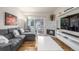 Cozy living room featuring a comfortable gray couch, fireplace, and outdoor view at 8465 Pebble Creek Way # 102, Highlands Ranch, CO 80126