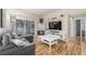 Inviting living room featuring a fireplace, hardwood floors, and a sliding glass door to a patio at 8465 Pebble Creek Way # 102, Highlands Ranch, CO 80126