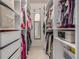 A spacious walk-in closet with ample storage, hanging racks, and shelving at 8465 Pebble Creek Way # 102, Highlands Ranch, CO 80126