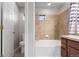 Bathroom with tile shower and bathtub, toilet, and a wooden vanity at 13000 W Grant Cir # C, Thornton, CO 80241