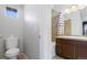 Bathroom with white toilet, tiled shower and bath, and a wooden sink cabinet at 13000 W Grant Cir # C, Thornton, CO 80241