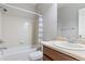 Standard bathroom with tiled tub and shower, wood vanity with sink, and toilet at 13000 W Grant Cir # C, Thornton, CO 80241