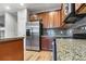 Kitchen featuring stainless steel appliances, granite counters, and wood cabinetry at 13000 W Grant Cir # C, Thornton, CO 80241