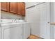 Functional laundry room with cabinets, washer, dryer, and sliding closet doors at 13000 W Grant Cir # C, Thornton, CO 80241