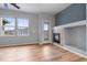 Living room with fireplace, wood floors, and three windows at 13000 W Grant Cir # C, Thornton, CO 80241