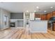 Inviting living space with fireplace, hardwood floors, and an open kitchen area with bar seating at 13000 W Grant Cir # C, Thornton, CO 80241