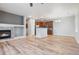 Open-concept living room featuring hardwood floors, a fireplace, and a kitchen with stainless appliances at 13000 W Grant Cir # C, Thornton, CO 80241