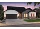 Charming home with a two-car garage, brick and white siding, and well-manicured landscaping at 22077 E Rockinghorse Pkwy, Aurora, CO 80016
