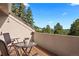 Relaxing outdoor balcony providing seating and scenic views of the trees and sky at 929 Coneflower Dr, Golden, CO 80401