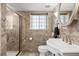 Bathroom featuring a glass shower, white sink, tile flooring, and traditional fixtures at 929 Coneflower Dr, Golden, CO 80401