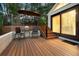 Inviting outdoor living space features a wooden deck with seating areas and steps leading to the yard and main level at 929 Coneflower Dr, Golden, CO 80401