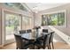 Bright dining area features large windows, a modern chandelier, and seating for six at 929 Coneflower Dr, Golden, CO 80401