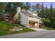 Eye-catching view of a multi-level home with an attached garage and outdoor deck overlooking a sloped backyard at 929 Coneflower Dr, Golden, CO 80401