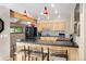 Updated kitchen featuring black appliances, natural wood cabinets, bar seating, and plenty of counter space at 929 Coneflower Dr, Golden, CO 80401