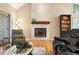 Warm and inviting living room with a stone fireplace, and comfortable seating at 929 Coneflower Dr, Golden, CO 80401