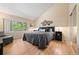 Bedroom with large windows, hardwood floors, a plush bed, and modern decor at 929 Coneflower Dr, Golden, CO 80401