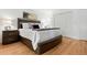 Bedroom features a plush bed, hardwood floors, closet, and matching nightstands with lamps at 929 Coneflower Dr, Golden, CO 80401