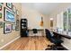Well-lit home office featuring hardwood floors, custom desks, and a large window at 929 Coneflower Dr, Golden, CO 80401