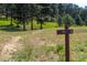 Scenic community walking trail, marked with signage and surrounded by natural beauty and wildflowers at 929 Coneflower Dr, Golden, CO 80401