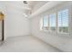 Bedroom bathed in natural light from large windows, new carpet, and clean white walls at 7865 E Mississippi Ave # 1502, Denver, CO 80247