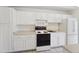 Bright kitchen with white cabinets, tiled floors, and modern appliances at 7865 E Mississippi Ave # 1502, Denver, CO 80247