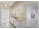 Bright kitchen featuring white cabinets, tiled floors, and stainless steel sink at 7865 E Mississippi Ave # 1502, Denver, CO 80247