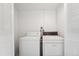 Functional laundry room features a white washer and dryer set and white walls at 7865 E Mississippi Ave # 1502, Denver, CO 80247