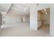 Expansive living room featuring new carpet, neutral walls, light fixtures, and access to the kitchen at 7865 E Mississippi Ave # 1502, Denver, CO 80247