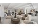Bright living room with hardwood floors, beamed ceilings, fireplace, and stylish decor at 7865 E Mississippi Ave # 1502, Denver, CO 80247
