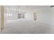 Bright and spacious living room featuring new carpet, neutral walls, and natural light from the sliding glass doors at 7865 E Mississippi Ave # 1502, Denver, CO 80247